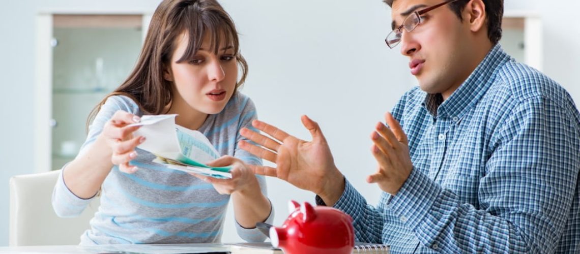 Young couple looking at family finance papers